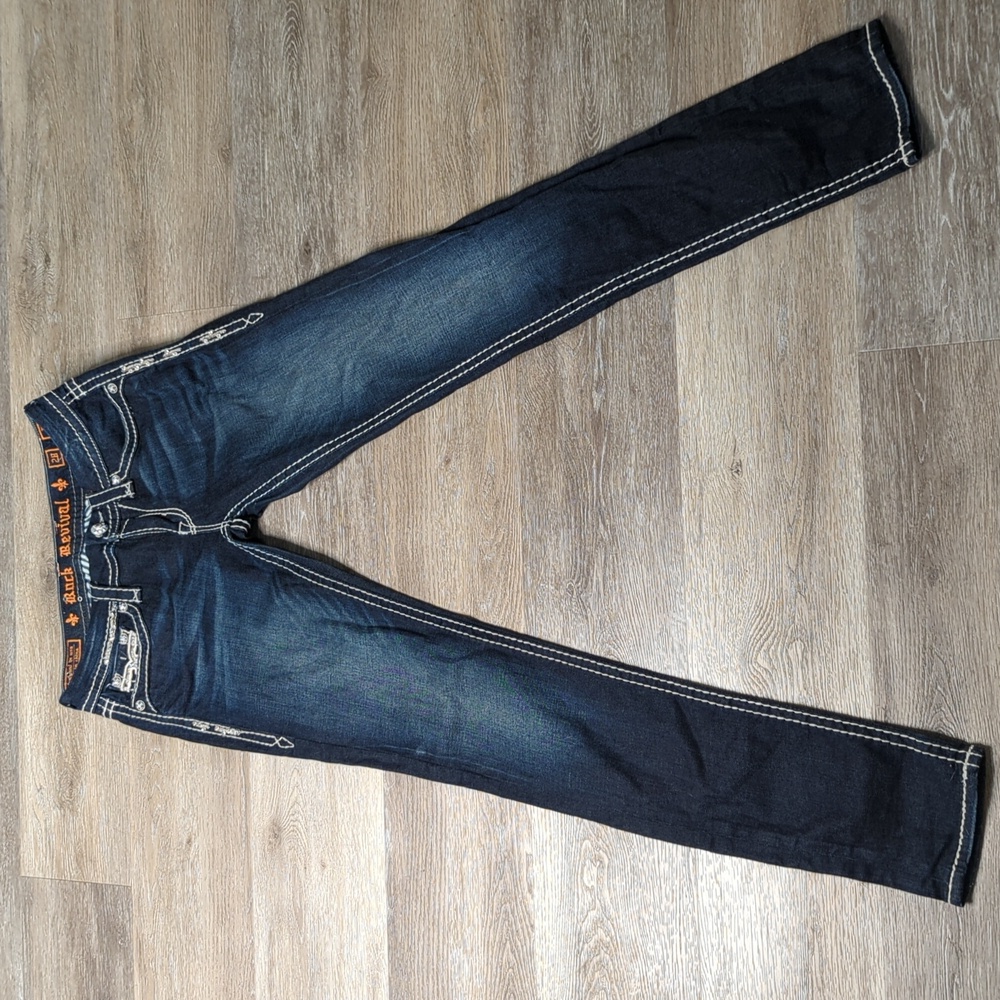 Rock Revival dark wash skinny jeans with bold white stitching and rhinestones